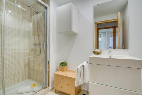 a white bathroom with a shower and a sink at Ideal Property Mallorca - Mar Blau in Alcudia
