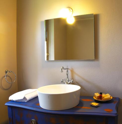 a bathroom with a sink and a mirror on a counter at La Maison De Vì in Carpaneto Piacentino