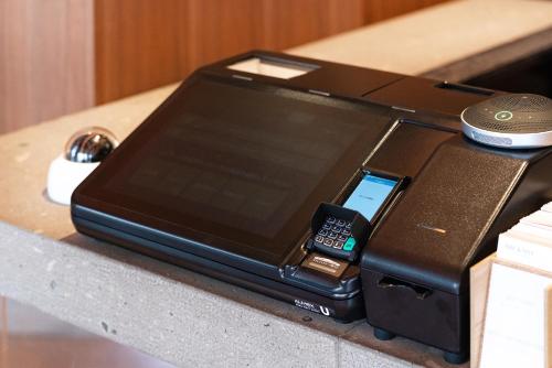 an electronic device with a cell phone on a table at THE KNOT SAPPORO in Sapporo