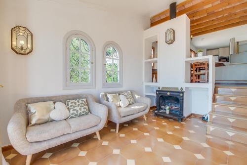 a living room with a couch and a fireplace at Ideal Property Mallorca - Ram de Mar in Font de Sa Cala