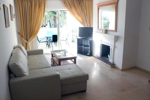 a living room with a couch and a fireplace at Hacienda Beach in Estepona
