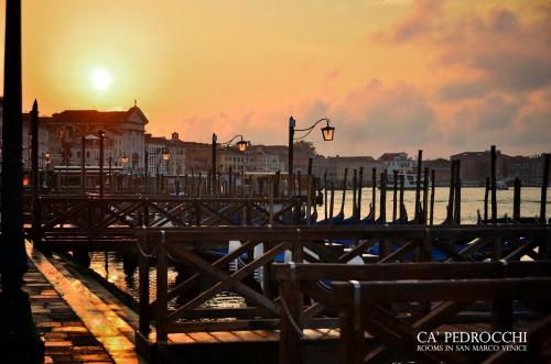 a pier with the sunset in the background at Ca' Pedrocchi in Venice