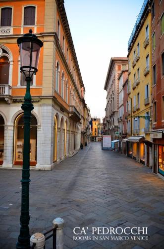 an empty street with a street light in a city at Ca' Pedrocchi in Venice