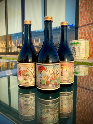 three bottles of wine sitting on a glass shelf at FFF Hotel in Hengchun