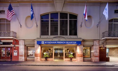 a building with flags on the front of it at Wyndham New Orleans French Quarter in New Orleans