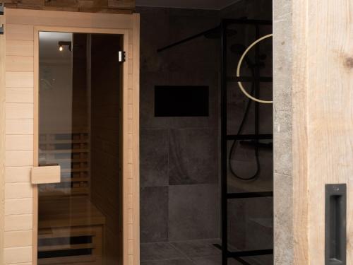 a shower with a glass door in a bathroom at Studio in Domburg near Beach and Golf in Renesse