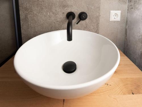 a white sink sitting on top of a wooden counter at Studio in Domburg near Beach and Golf in Renesse
