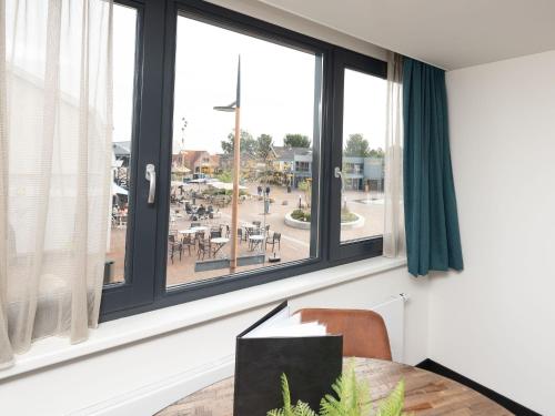 a dining room with a table and a window at Studio in Domburg near Beach and Golf in Renesse