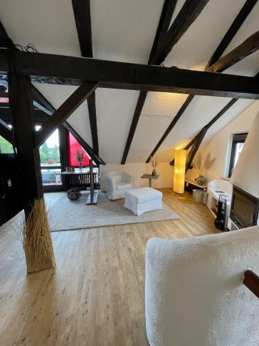 a large living room with white furniture in a attic at Ferienwohnung Brückenkopf OG in Hameln