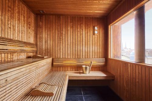 a sauna with a bench and a window in it at InterContinental Bordeaux Le Grand Hotel by IHG in Bordeaux