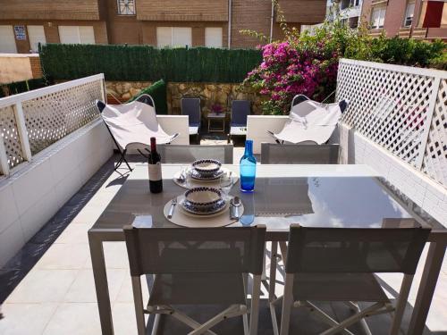 a table and chairs on a rooftop patio at Duplex a 25 metros de la playa in Somo