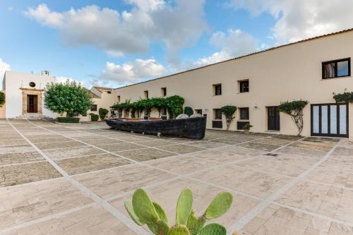 an exterior view of a building with a courtyard at La Tonnara di Bonagia Resort in Valderice
