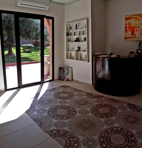 a living room with a rug on the floor at La Maison Des Oliviers in Marrakesh