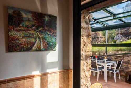 a painting on the wall of a room with a table at Casa rural la castañona in Buiza