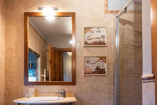 a bathroom with a sink and a mirror at Casa rural la castañona in Buiza