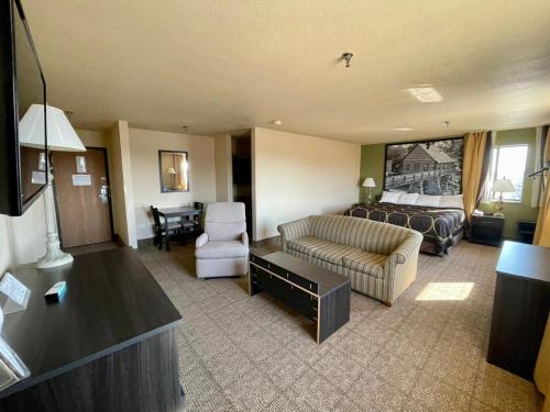a living room with a couch and a chair and a table at Super 8 by Wyndham Macon in Macon