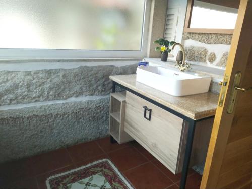 a bathroom with a sink and a mirror at Welcoming villa near Penafiel with pool in Abol de Cima