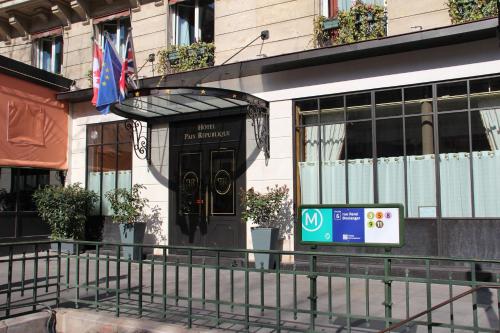 a building with a sign in front of it at Hotel Paix Republique in Paris