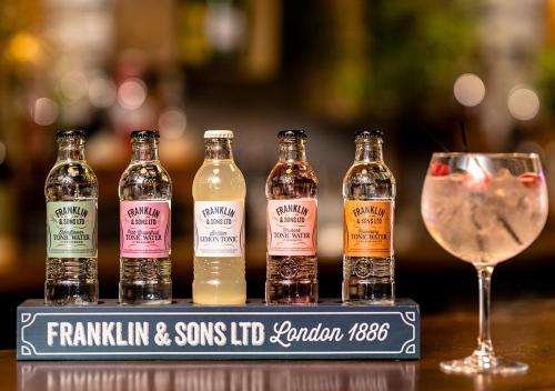 a group of bottles and a glass of wine at Dragonfly Hotel King's Lynn in Kings Lynn