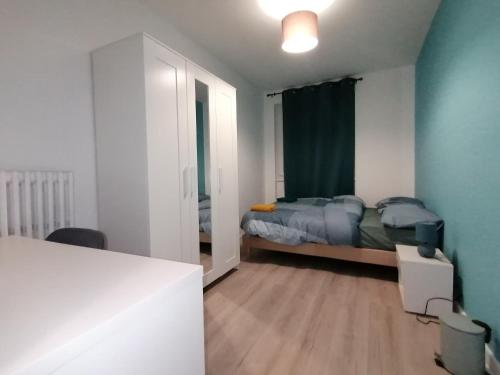 a small bedroom with a bed and a window at Hadriel Host in Clermont-Ferrand