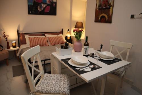 a room with a bed and a table with plates and flowers at "Art Studio" Old Town Rovinj-Holiday in Rovinj