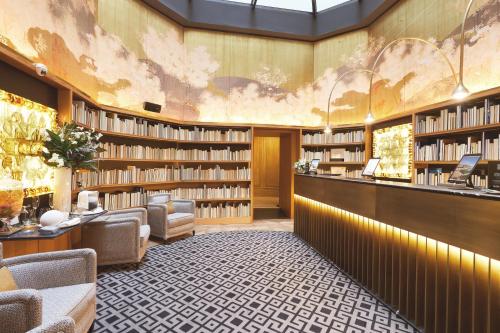 a library with shelves of books on the wall at BLESS Hotel Madrid - The Leading Hotels of the World in Madrid