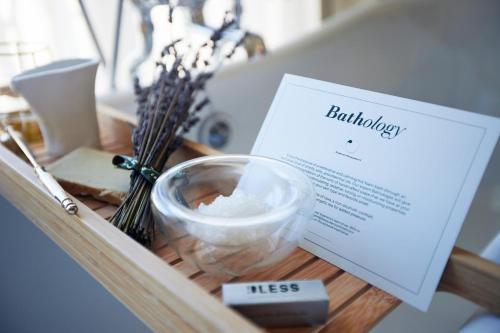 a tray with a book and a bowl of white powder at BLESS Hotel Madrid - The Leading Hotels of the World in Madrid