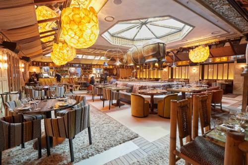 a restaurant with tables and chairs and lights at BLESS Hotel Madrid - The Leading Hotels of the World in Madrid