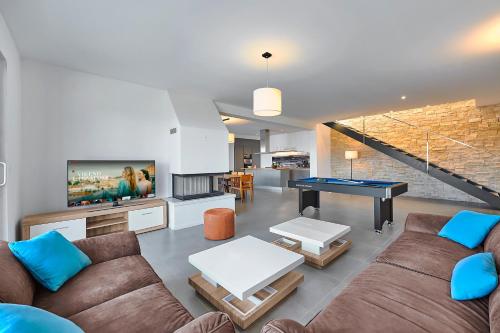 a living room with a couch and a ping pong table at Motovun Villas in Motovun