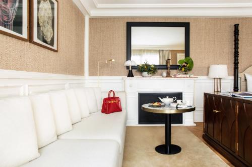 a living room with a white couch and a table at BLESS Hotel Madrid - The Leading Hotels of the World in Madrid