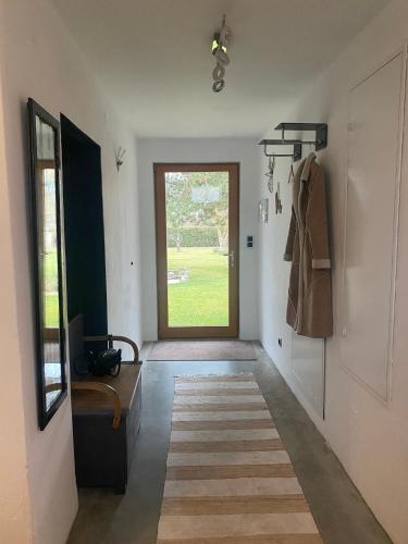 a hallway with a large window and a door at HalterHausPuch in Puch