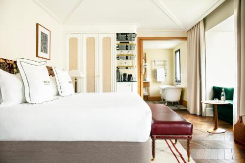 a bedroom with a white bed and a living room at BLESS Hotel Madrid - The Leading Hotels of the World in Madrid