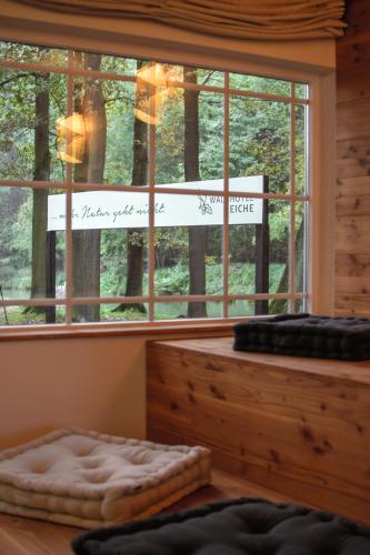 a room with a window with a bed and a sign at Waldhotel Eiche in Burg