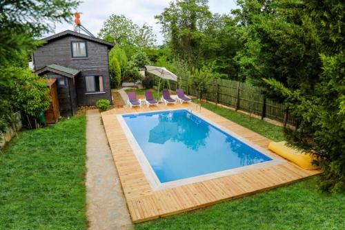 a swimming pool in the backyard of a house at Çınarhan Villas in Agva
