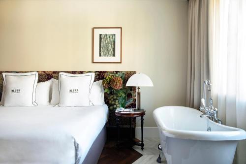 a hotel room with a bed and a bath tub at BLESS Hotel Madrid - The Leading Hotels of the World in Madrid