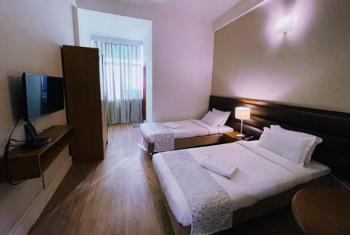 En eller flere senger på et rom på Hotel Tragopan