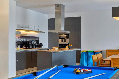 a kitchen with a pool table in the middle of it at Motovun Villas in Motovun