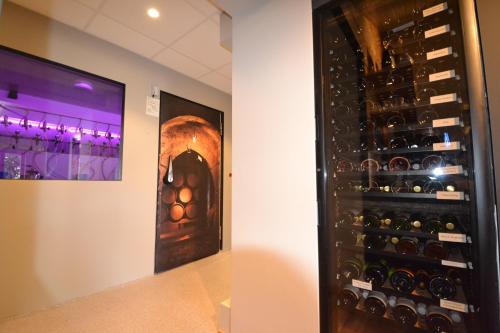 a room with a bunch of wine bottles in a wall at Hotel Bockelmann in Bispingen