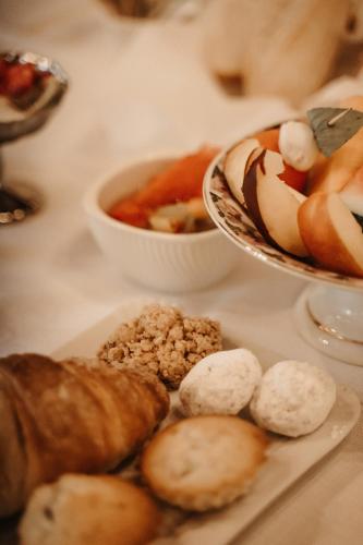 a table with a plate of food and bowls of food at La Celeste Galeria in Mantova