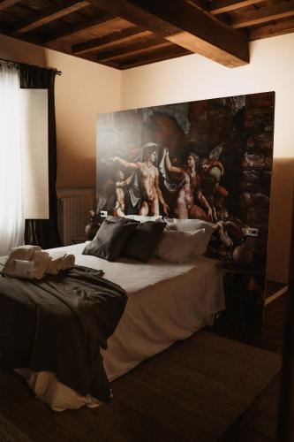a bedroom with a large painting on the wall at La Celeste Galeria in Mantova