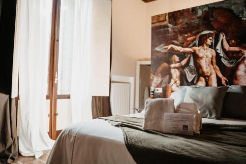 a bedroom with a bed with a painting on the wall at La Celeste Galeria in Mantova