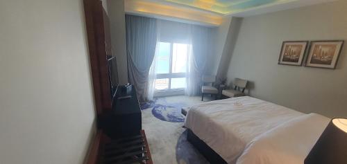 a hotel room with a bed and a window at Fleet Club Mahrousa in Alexandria