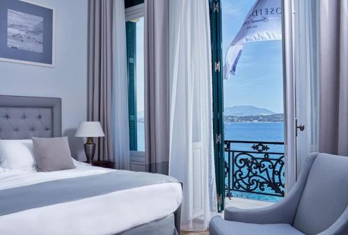 a hotel room with a view of the ocean at Poseidonion Grand Hotel in Spetses