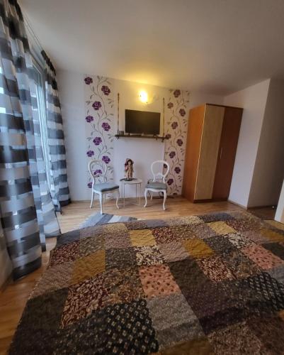 a bedroom with a quilt on the wall at House of Julia in Sighişoara