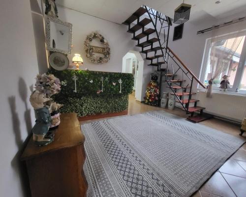 a living room with a staircase and a rug at House of Julia in Sighişoara
