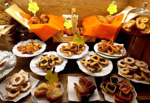 a table topped with plates of pastries and pies at Casa Dominova de Luxe in Sorrento