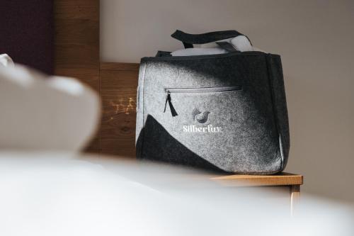 a black bag sitting on top of a table at Hotel Silberfux in Sankt Veit im Pongau