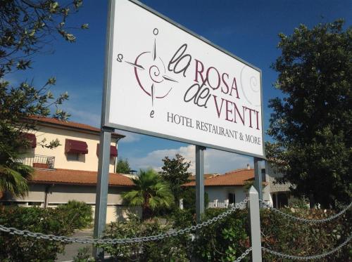 a sign for a hotel in front of a building at Hotel La Rosa Dei Venti in Albinia