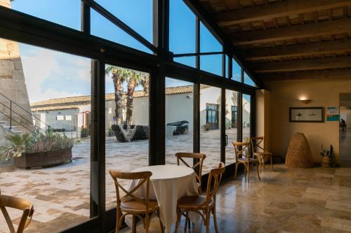 a dining room with a table and chairs at La Tonnara di Bonagia Resort in Valderice