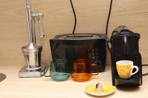 a toaster and coffee cups on a counter at "Art Studio" Old Town Rovinj-Holiday in Rovinj
